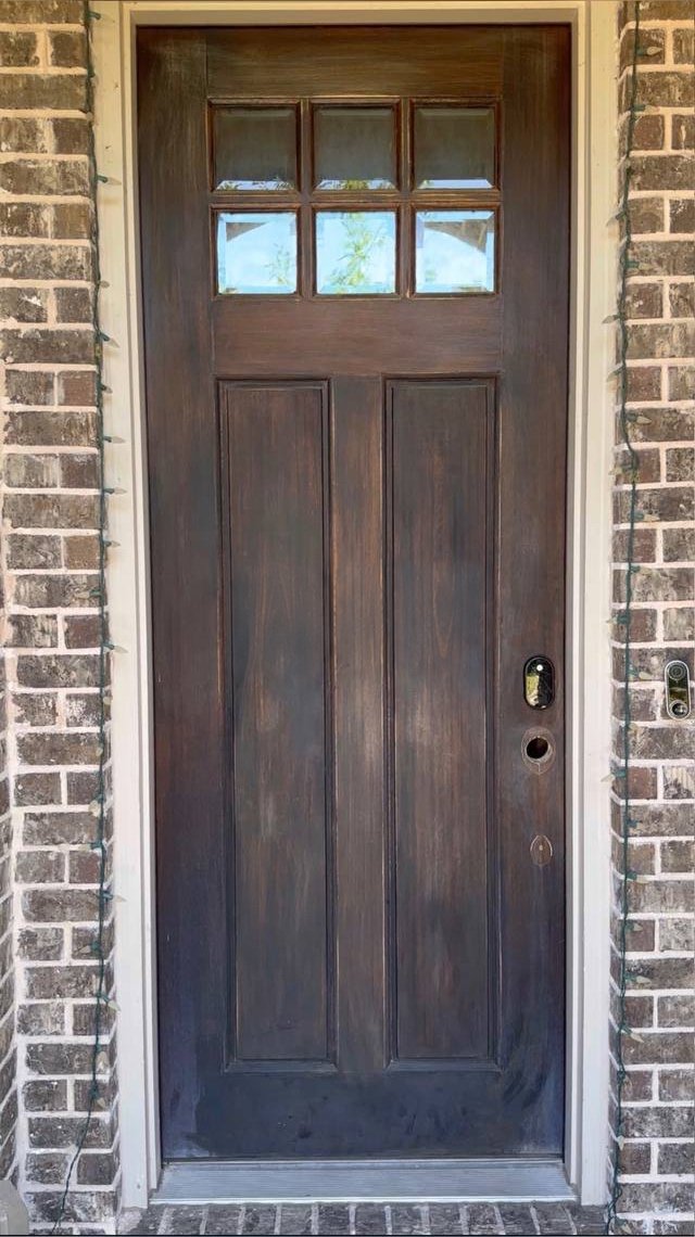 Front door before: worn wood stain