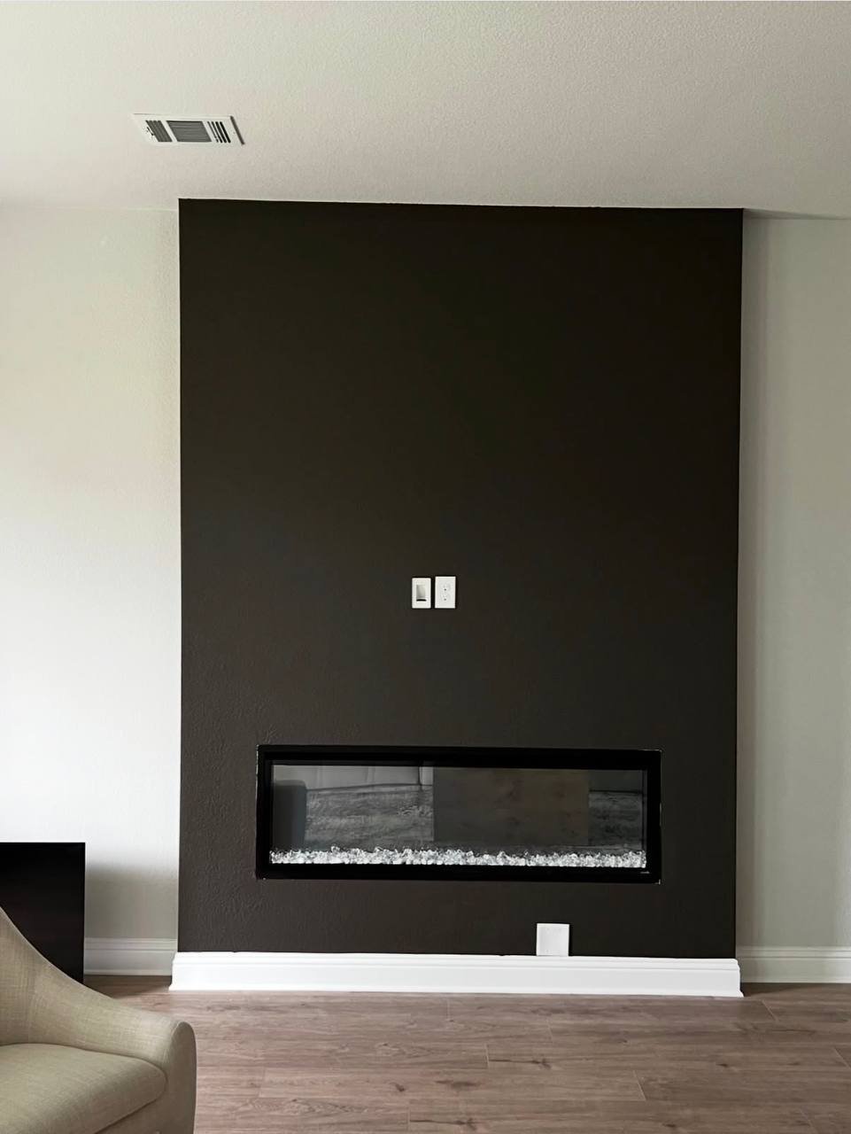 Fireplace wall after: deep charcoal finish