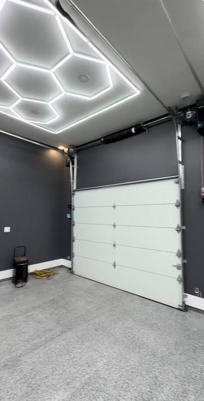 Garage after: charcoal walls under hexagon lights