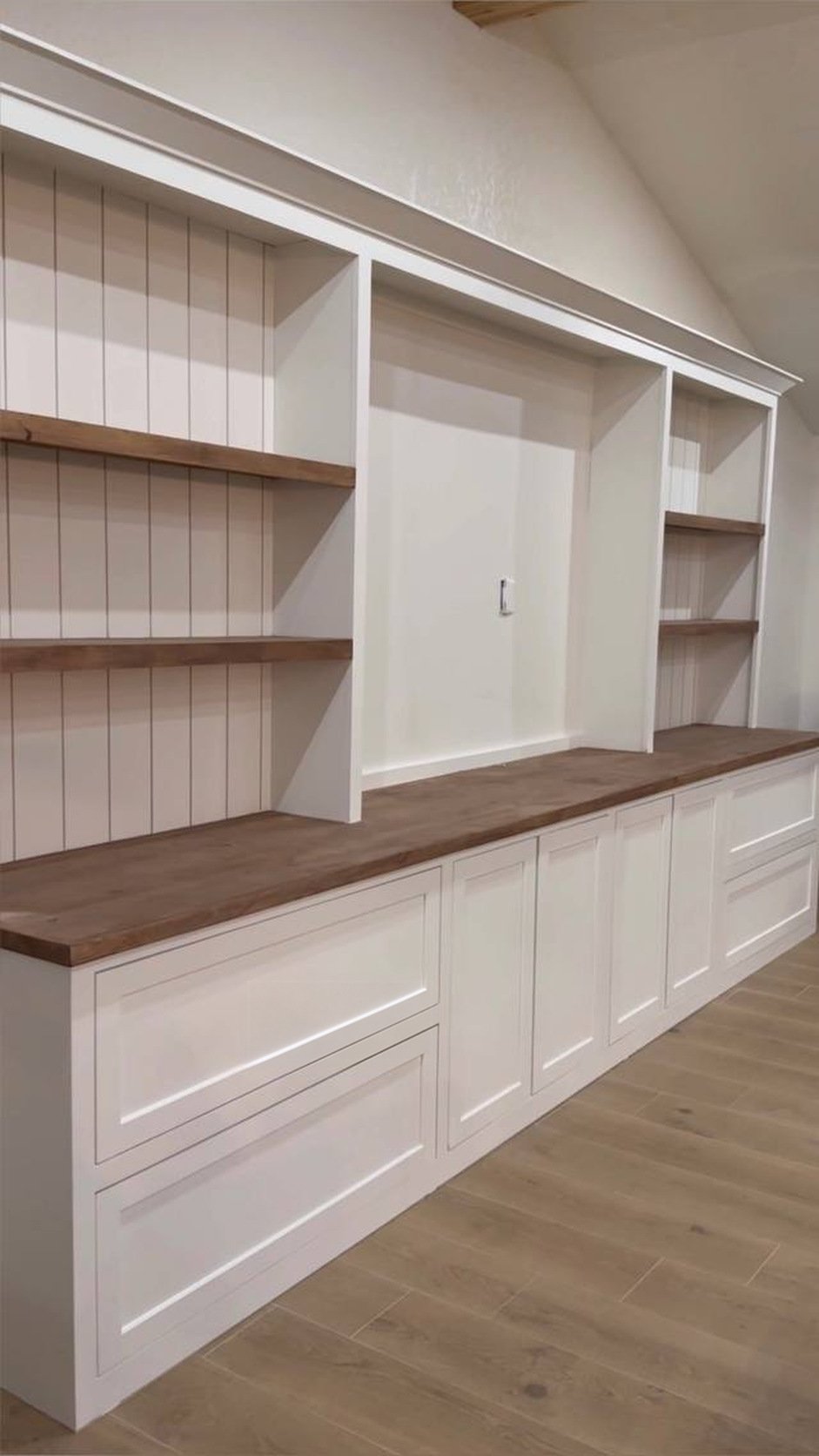 Built-in shelves after: white painted cabinetry with stained wood tops